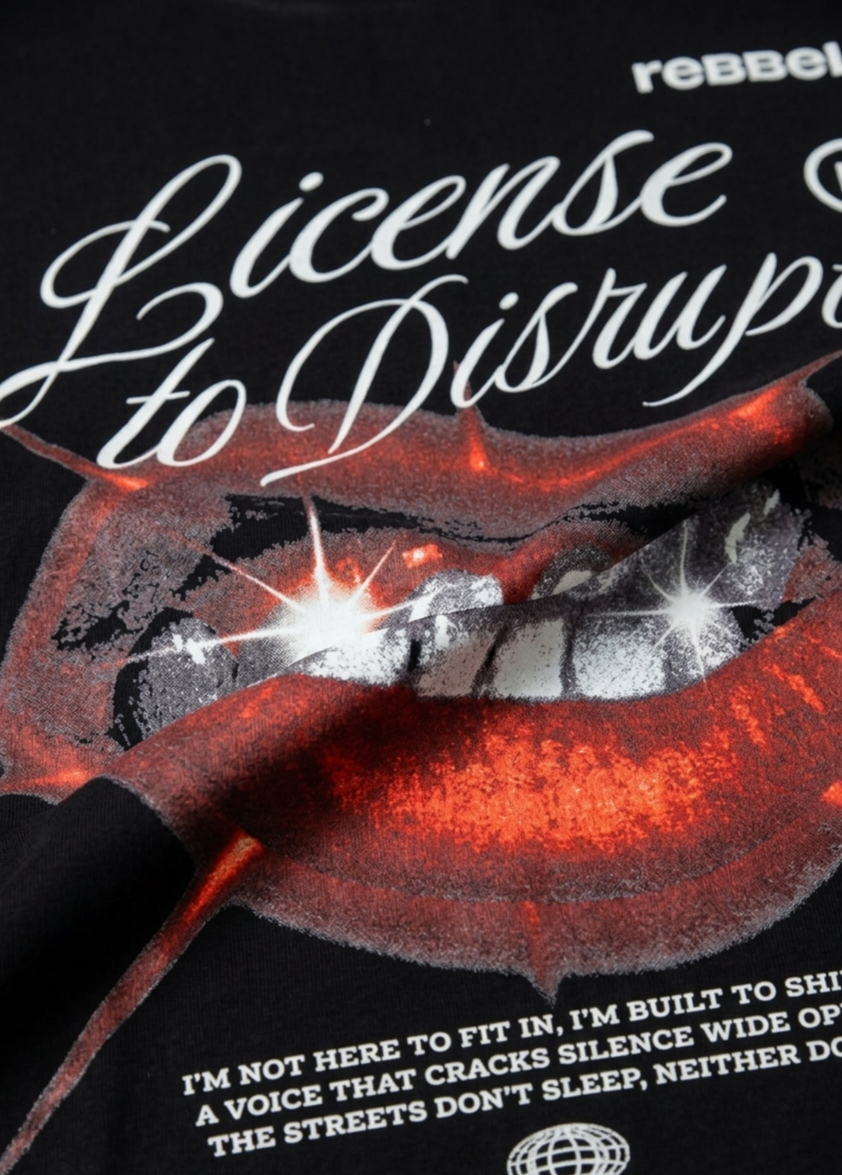 Black t-shirt with red lips graphic and text on a dark background