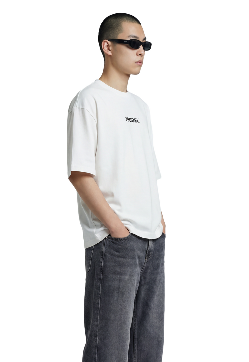 Person wearing a white t-shirt with text and dark jeans on a white background